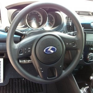 Blue K on te steering wheel